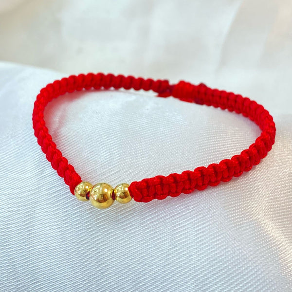 PULSERA ROJA TEJIDA CON CENTRO DE TRES BALINES